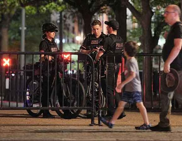 People walk in front of barricades used to block the entry to Lafayette Park, following US strikes on Iran's nuclear facilities, in Washington, DC, US, Jun 21, 2025. REUTERS/Ken Cedeno