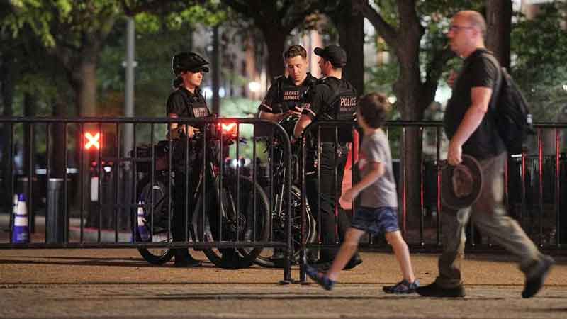People walk in front of barricades used to block the entry to Lafayette Park, following US strikes on Iran's nuclear facilities, in Washington, DC, US, Jun 21, 2025. REUTERS/Ken Cedeno